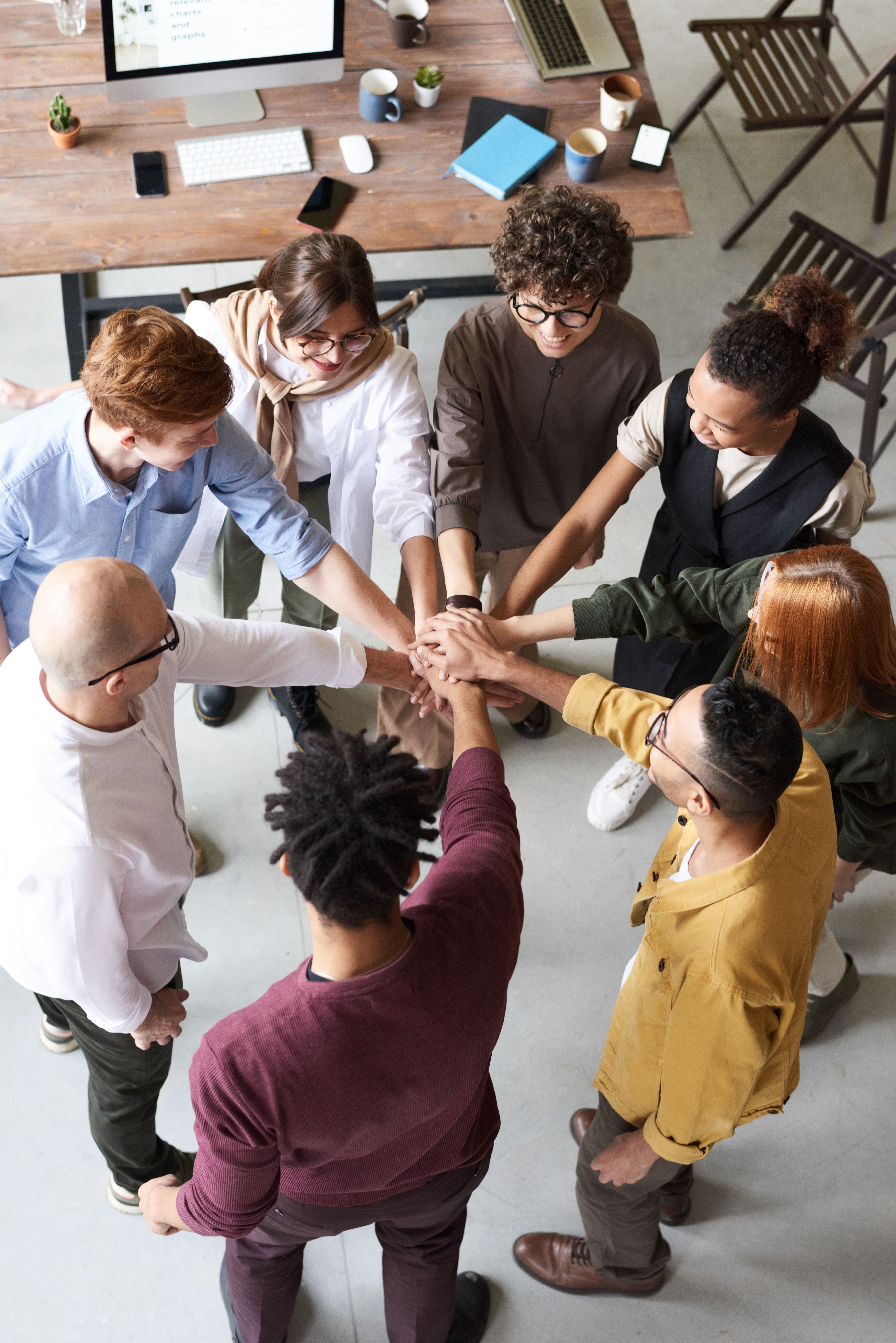 A diverse group of professionals joining hands in collaboration
